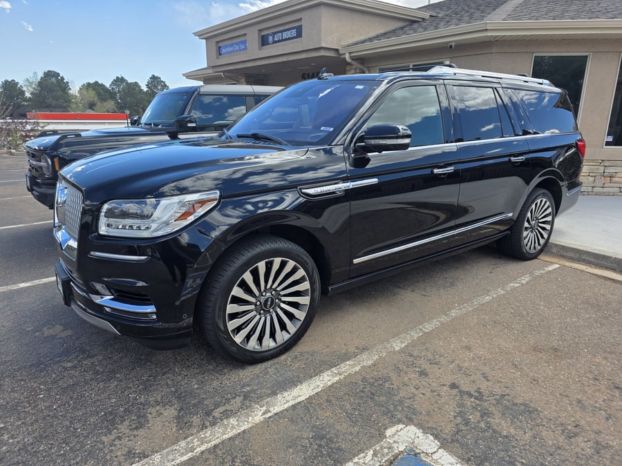 A black Lincoln Navigator ready outside the RH Auto Brokers office