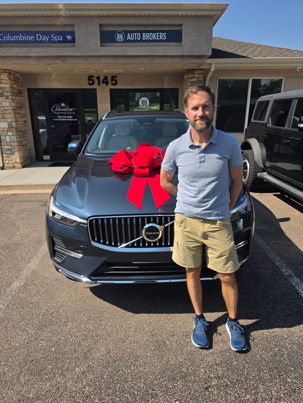 A client with his new Volvo outside RH Auto Brokers in Colorado Springs