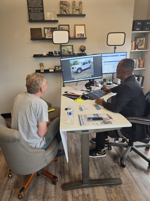 Ronnie Haskins walking a client through his options at the RH Auto Brokers office Ronnie Haskins walking a client through his options at the RH Auto Brokers office