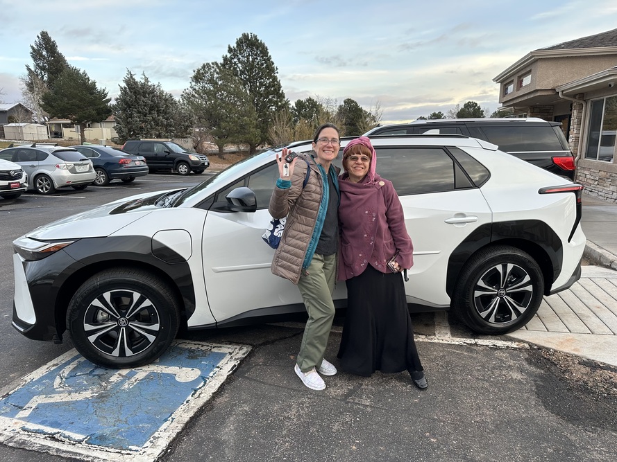 Two happy clients holding up the keys to their new Toyota at RH Auto Brokers