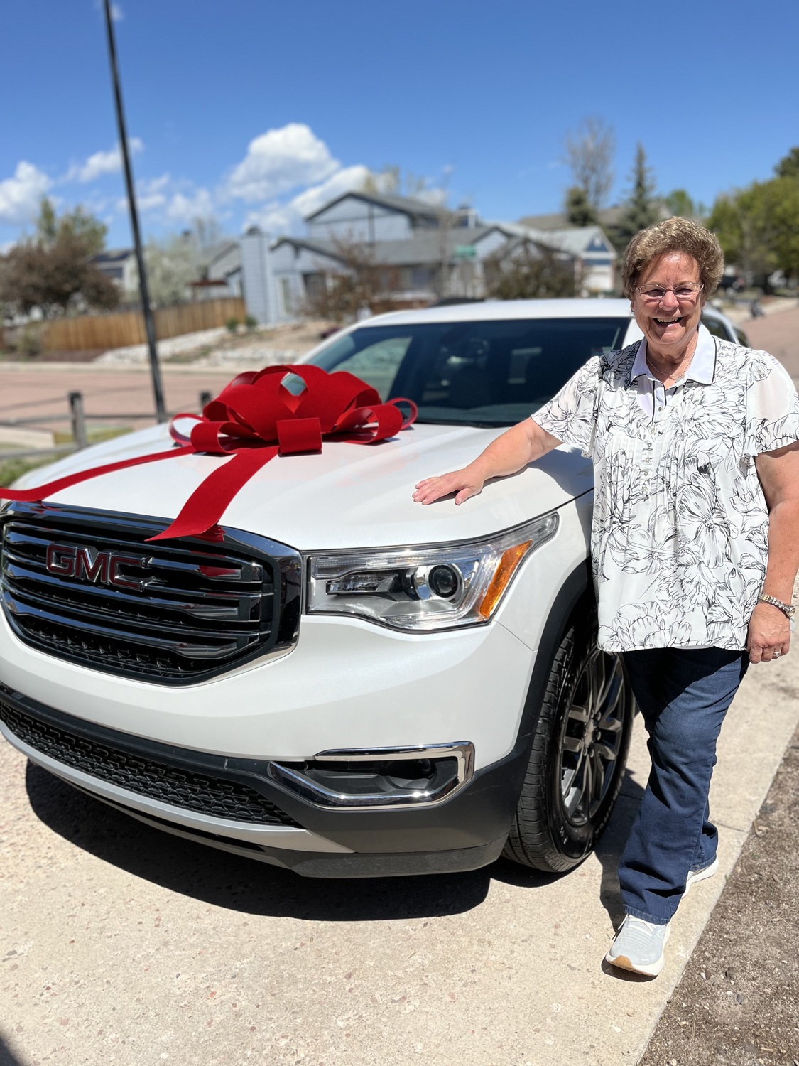 A happy client with her new GMC at RH Auto Brokers