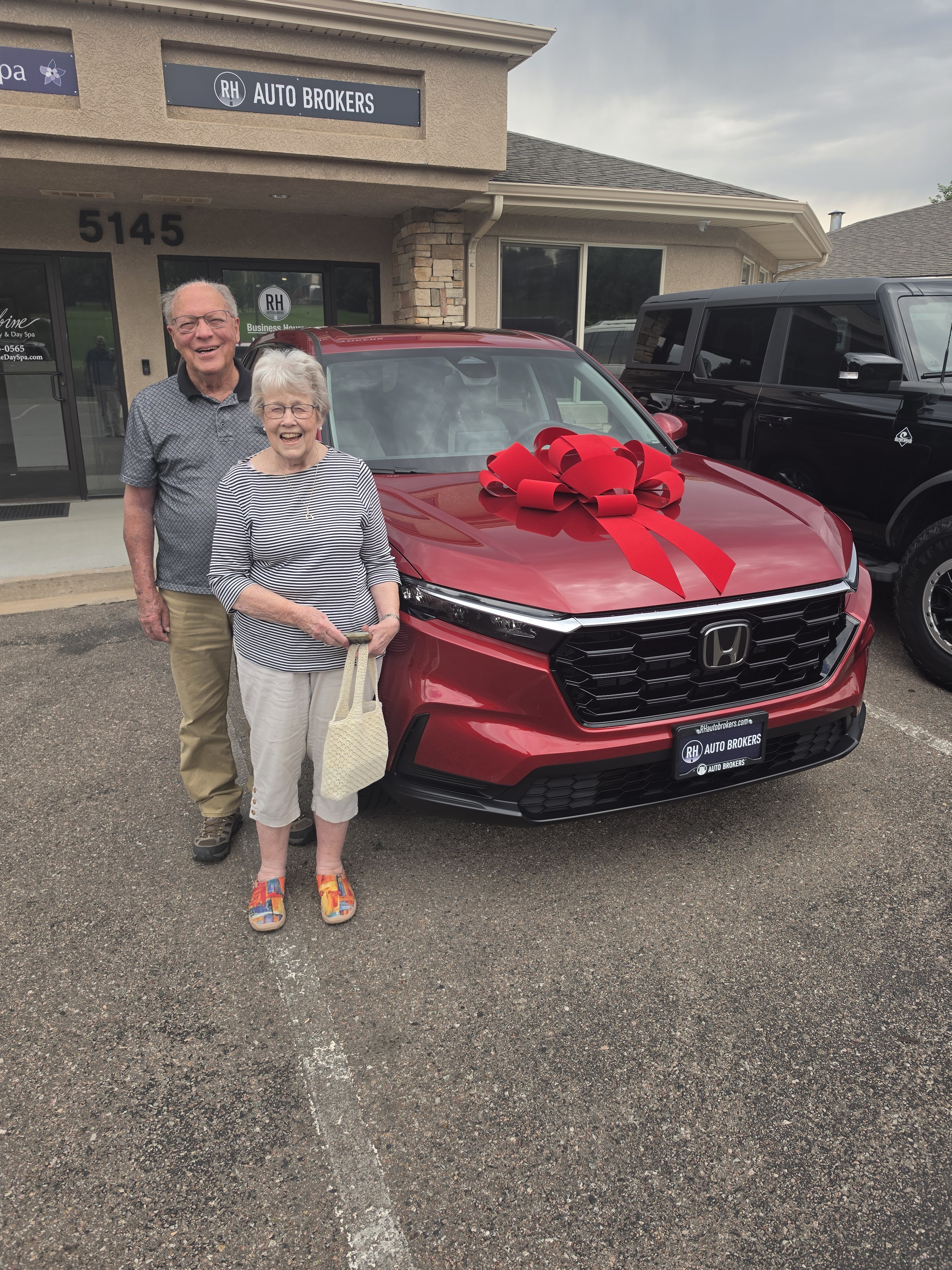 Happy clients with their new Honda CR-V at RH Auto Brokers