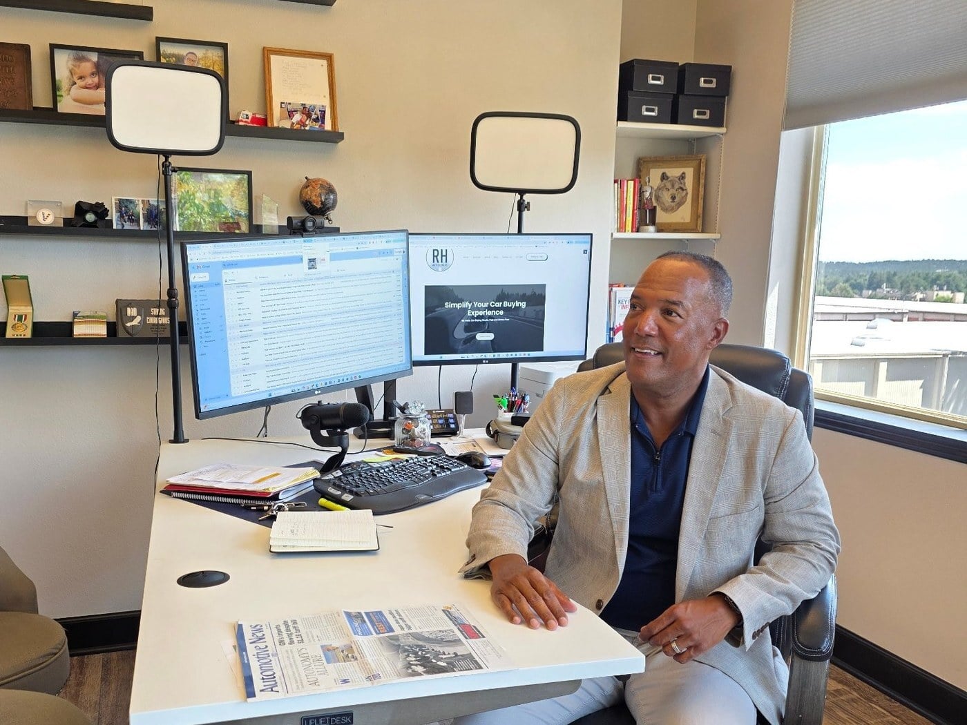 Ronnie Haskins at his desk at RH Auto Brokers in Colorado Springs